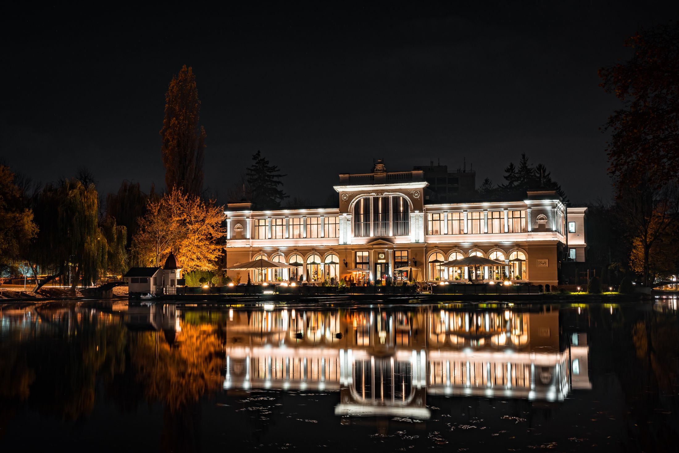 Lakeside home illuminated at night